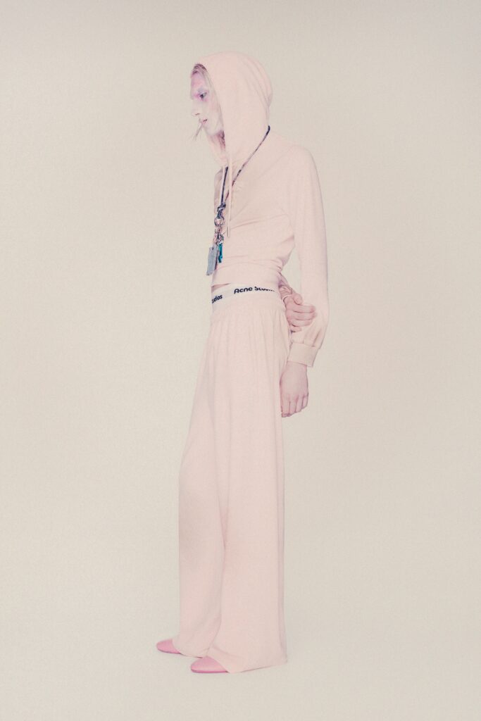A relaxed pink hoodie with long sleeves paired with wide-leg pants for a comfortable look.