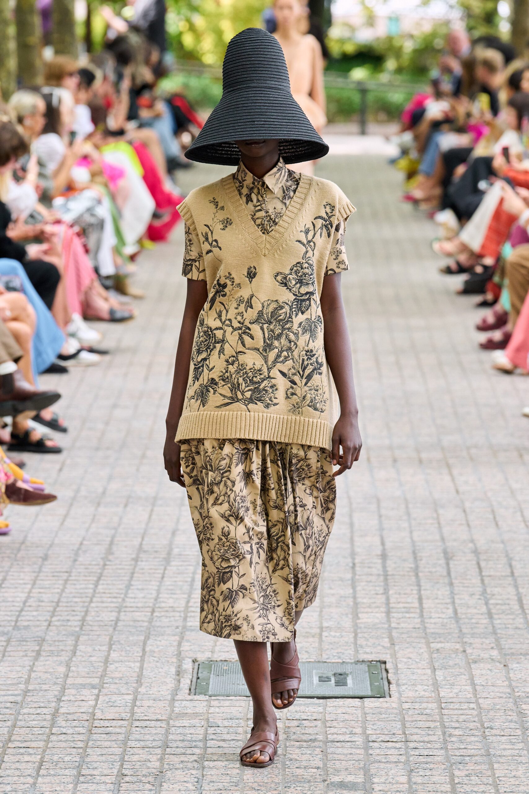 beige floral midi dress with black hat