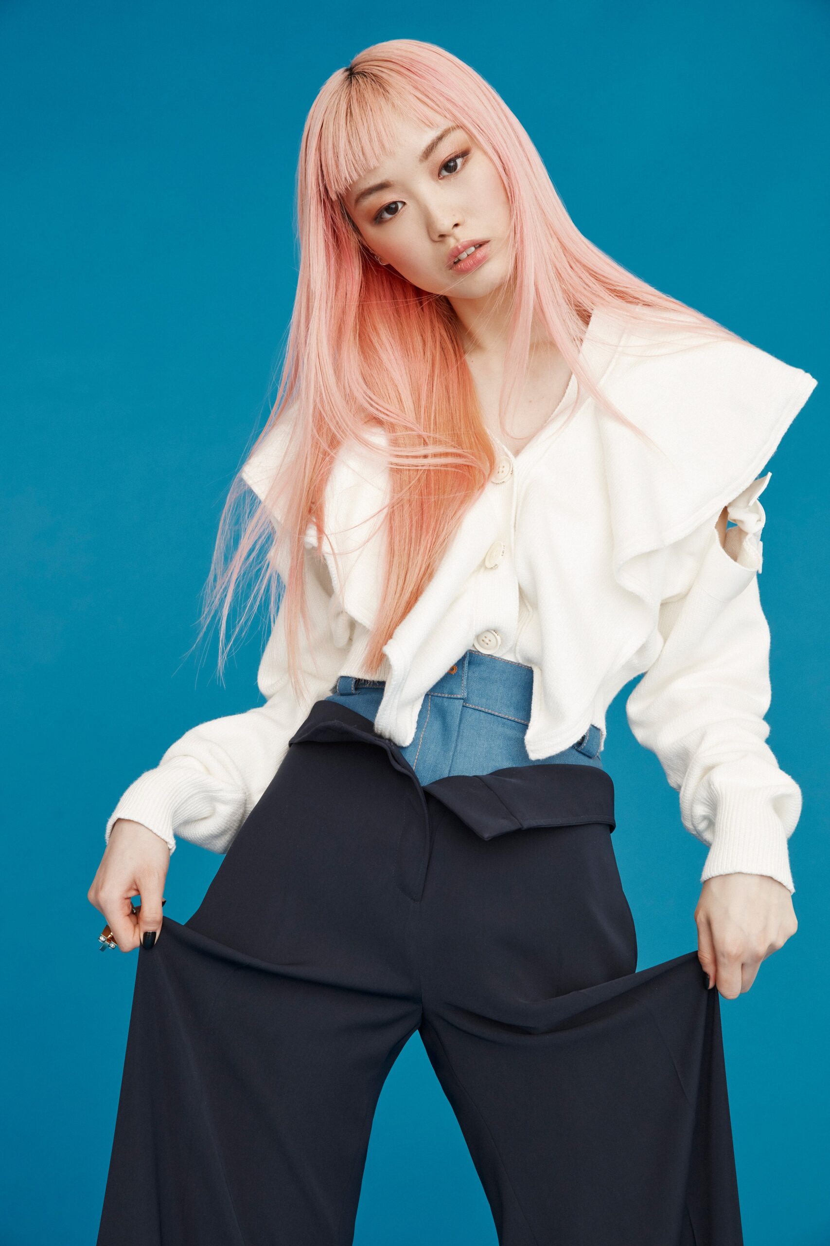 white ruffled blouse with blue pants