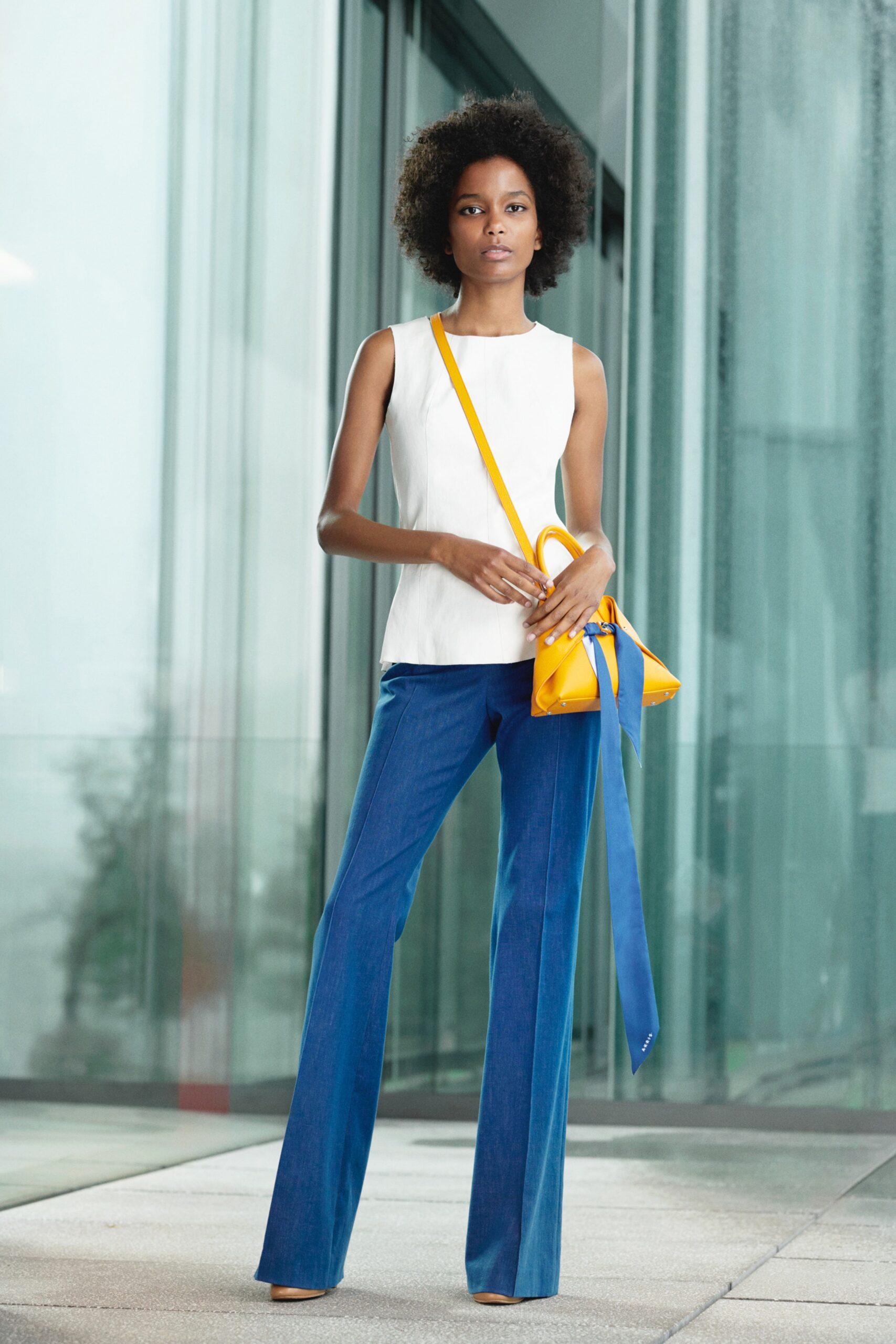 white fitted top and blue flared pants