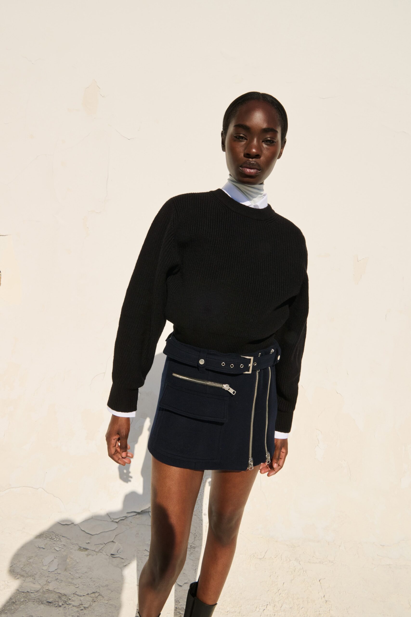 black sweater and navy skirt