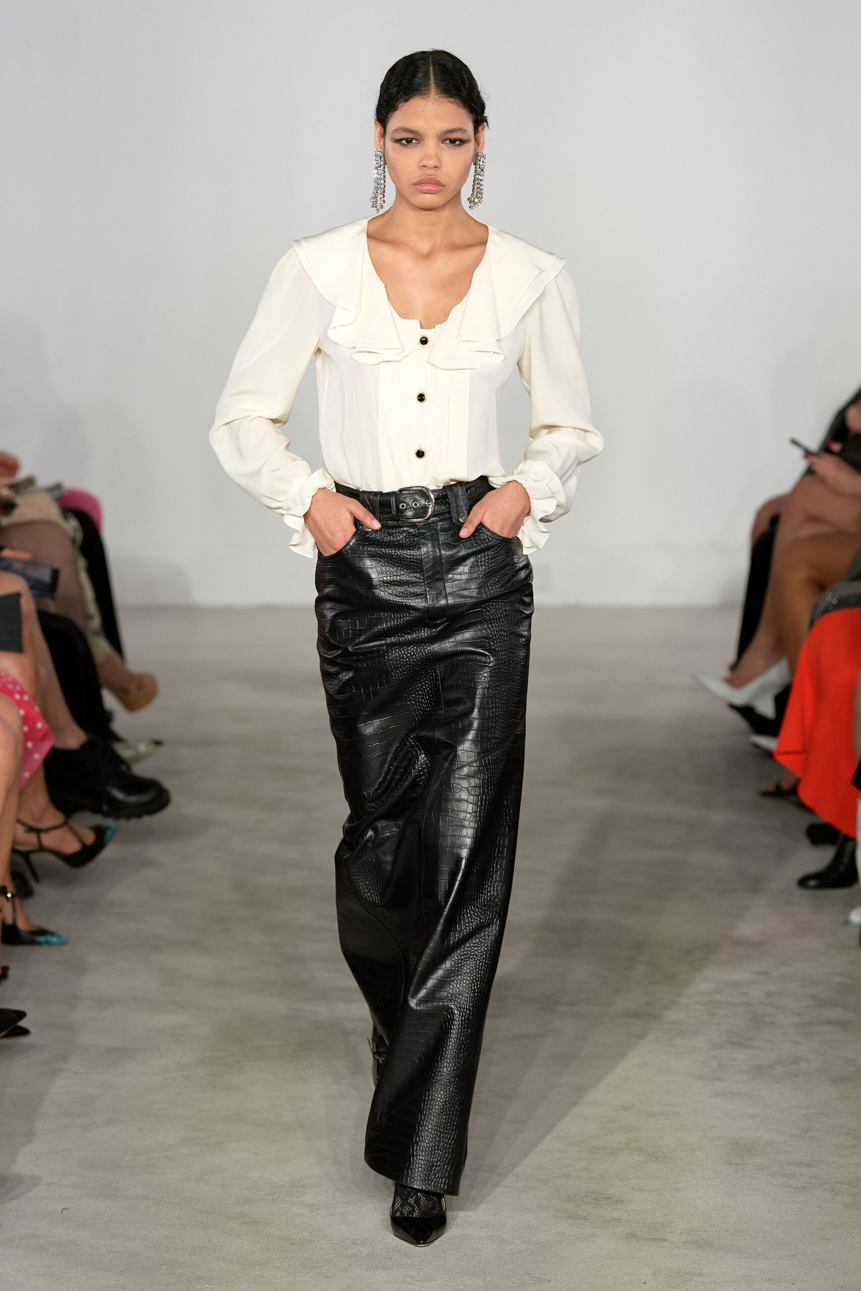 white ruffled blouse and black leather pants