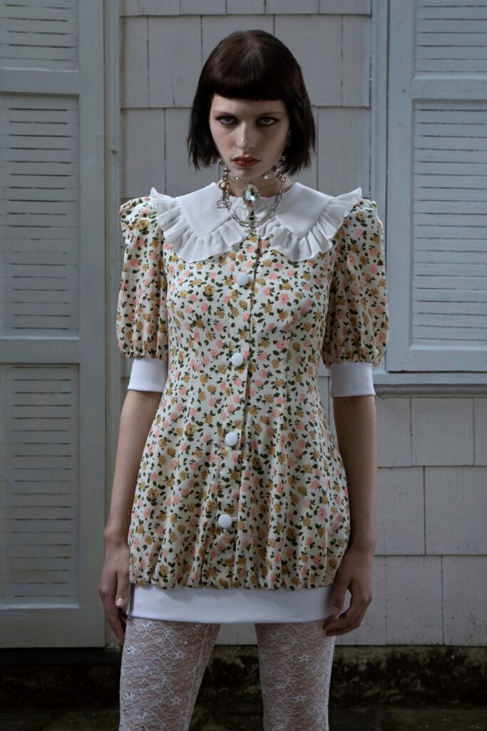A fitted multicolor floral dress with a collared neckline and buttoned front.