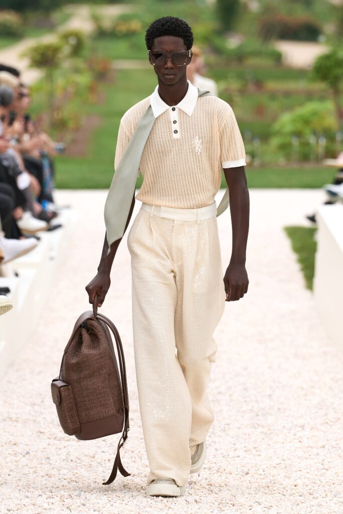 A relaxed beige cotton shirt with a collared neckline paired with straight-leg pants.