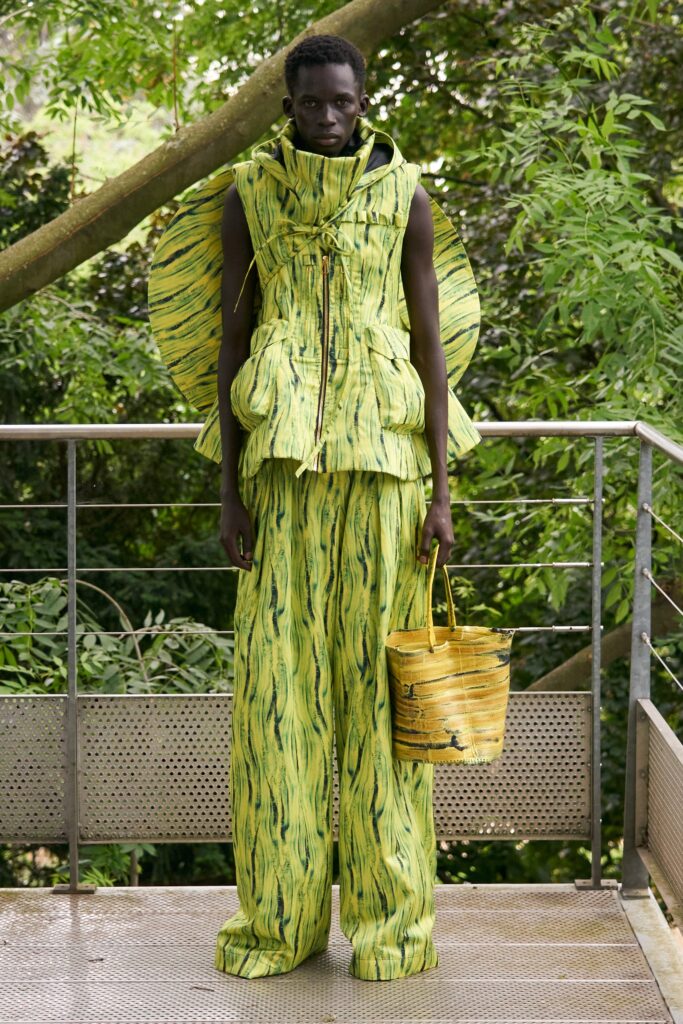 A relaxed fit sleeveless jacket with a hood and printed pants in yellow and green.