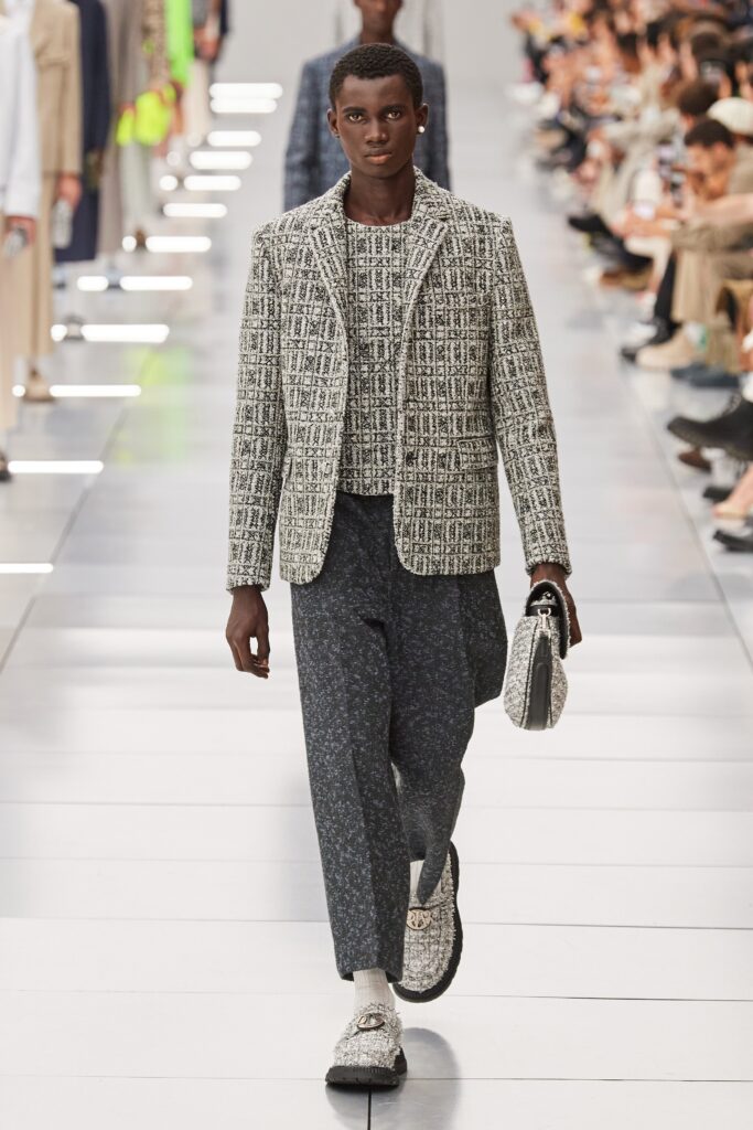 A tailored black and white checked blazer paired with stylish pants.