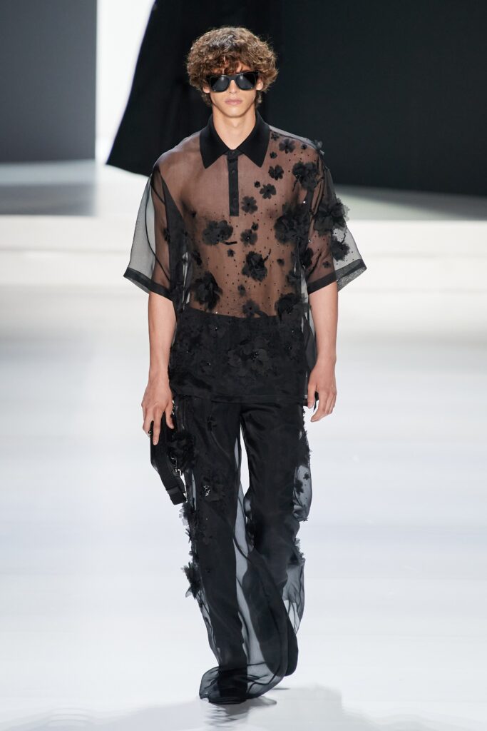 A relaxed black sheer shirt with short sleeves and embroidered details paired with matching pants.