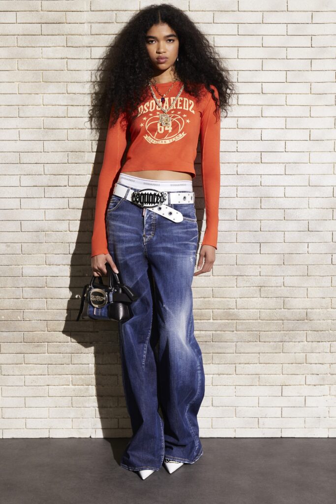 orange fitted long-sleeve top with blue jeans