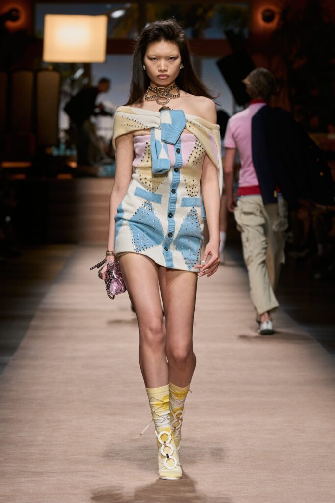 A fitted multicolor dress with a collared neckline and buttoned asymmetric design.