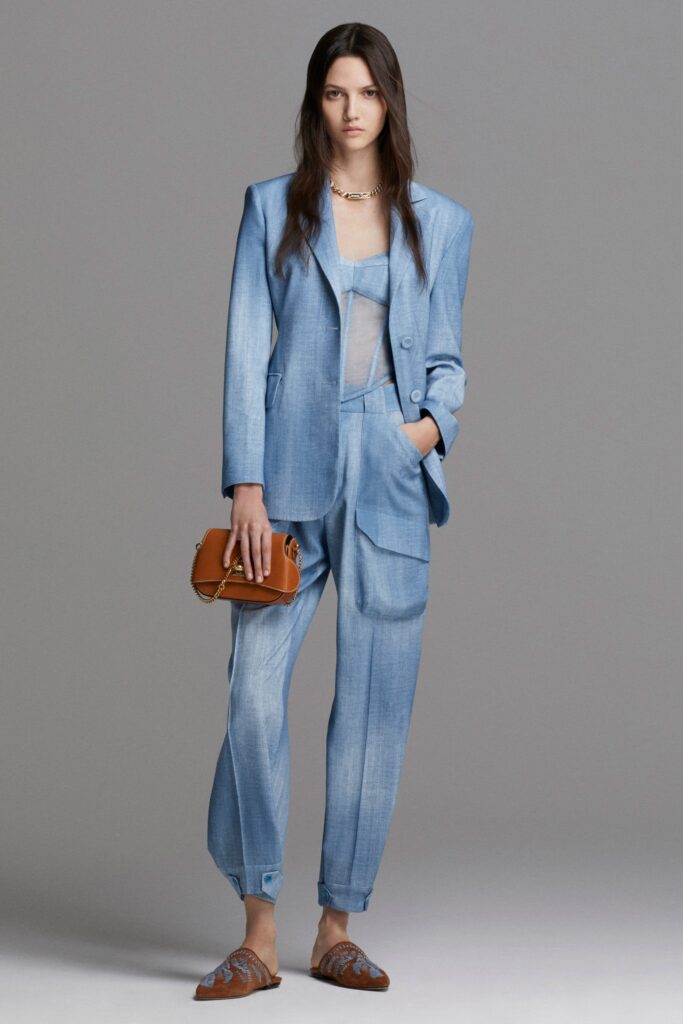 A relaxed blue denim blazer paired with matching pants featuring a collared design.