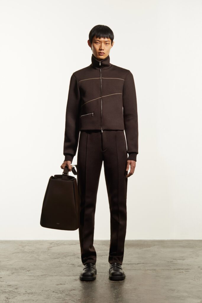 A fitted brown cotton jacket with long sleeves and a collared design paired with matching pants.