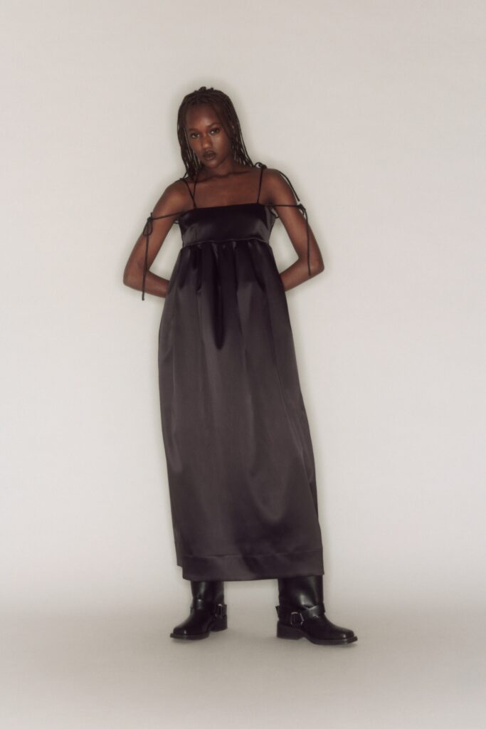 A relaxed black silk sleeveless dress with a V-neckline and maxi length.