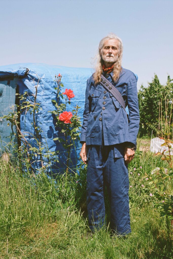 A relaxed blue cotton suit with long sleeves and a collared design, featuring button details.