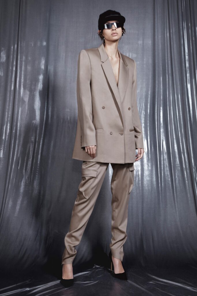 An oversized beige blazer with long sleeves and double-breasted design paired with matching pants.
