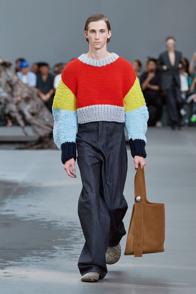 A relaxed color-blocked sweater with long sleeves paired with wide-leg denim pants.
