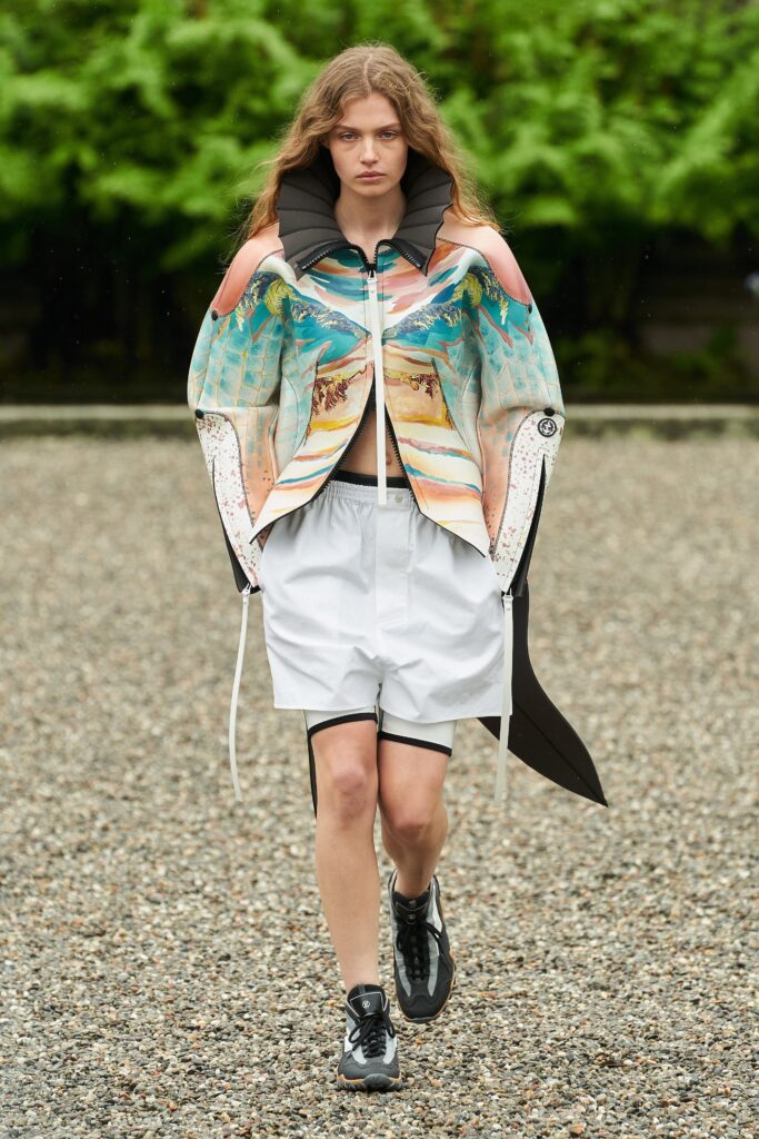 A relaxed fit multicolor printed jacket paired with white shorts, featuring a collared design.