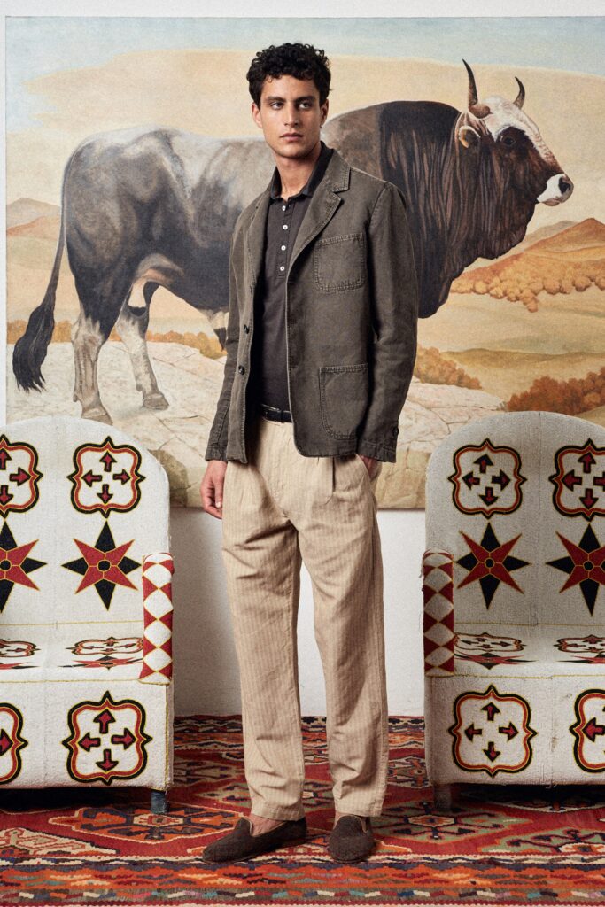 A relaxed gray cotton jacket with a collared neckline paired with beige striped pants.