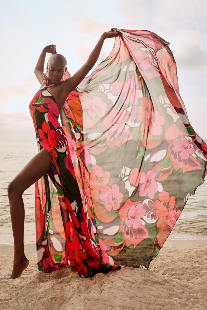 A relaxed floral printed chiffon dress with a sleeveless halter design and flared silhouette.