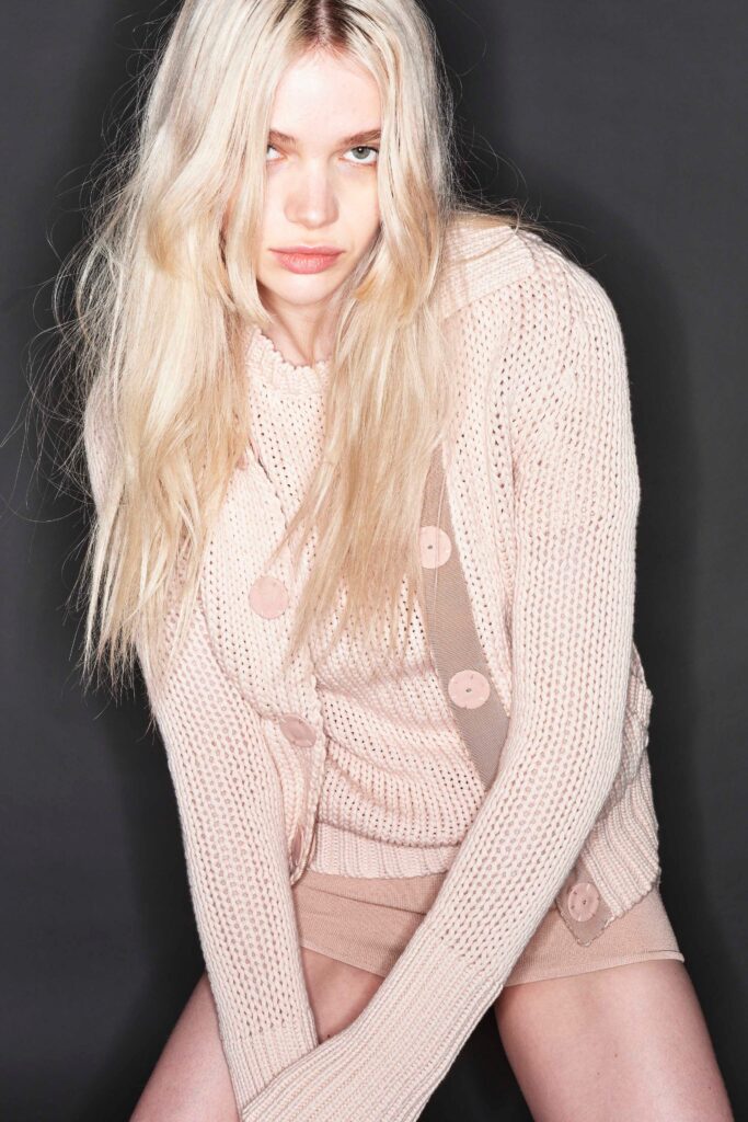 pink fitted cardigan with beige skirt