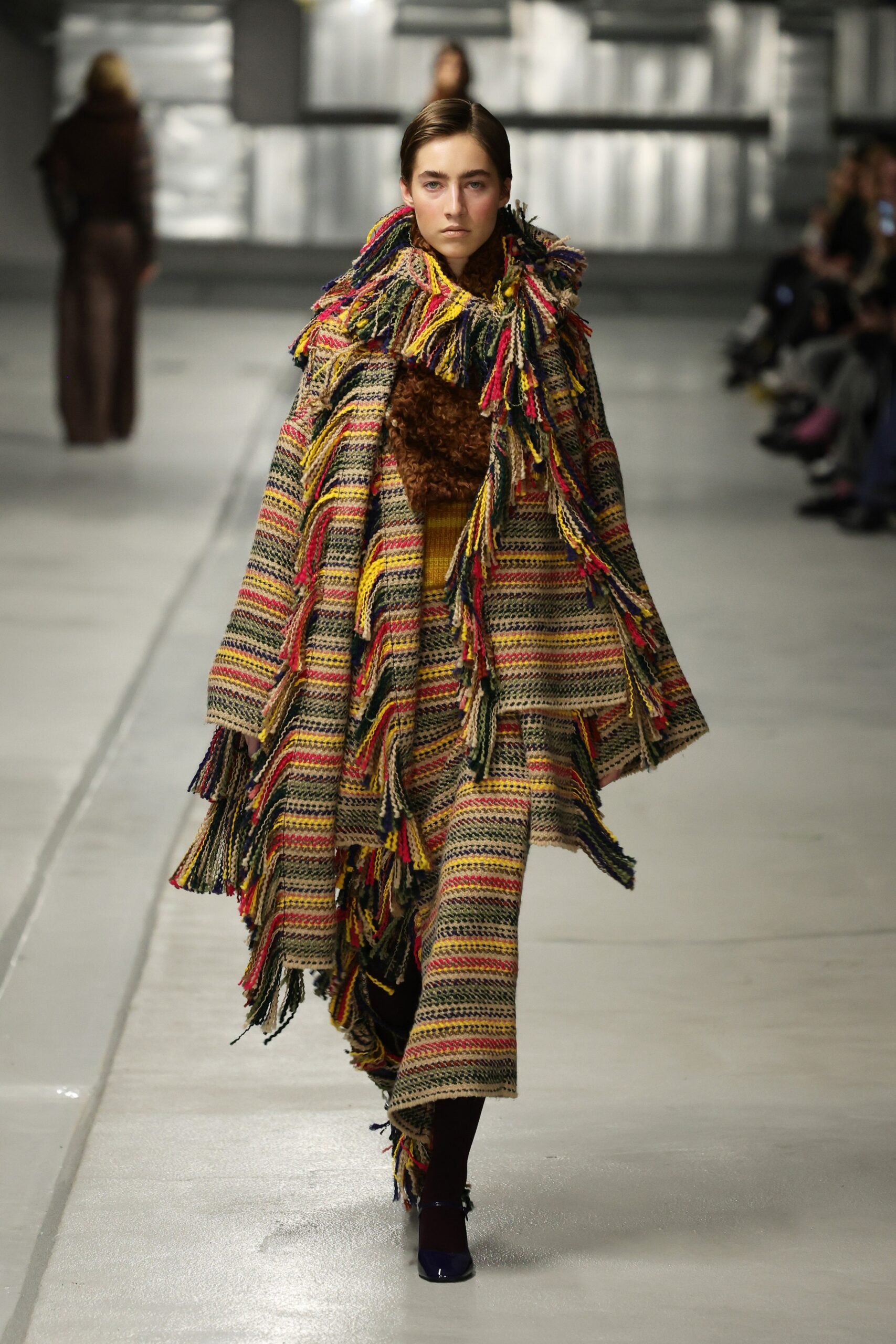 multi-colored wool cape and brown fitted dress