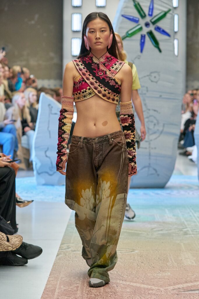 A relaxed fit multicolor sleeveless top paired with wide-leg printed pants.