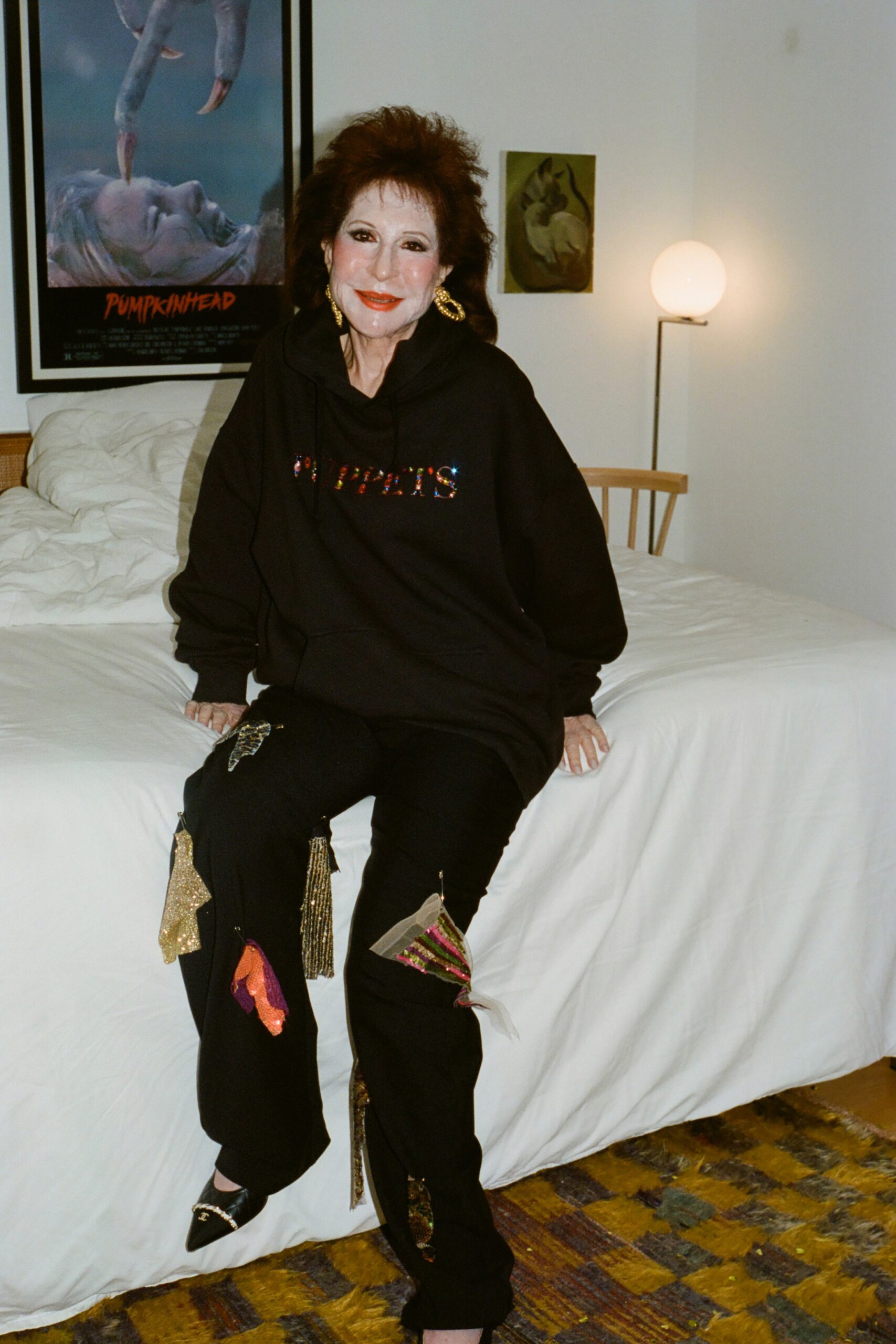 A relaxed black hoodie with printed details paired with black pants.