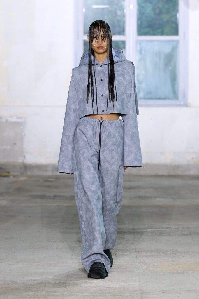 A relaxed gray jacket with long sleeves and matching pants, featuring a layered design.