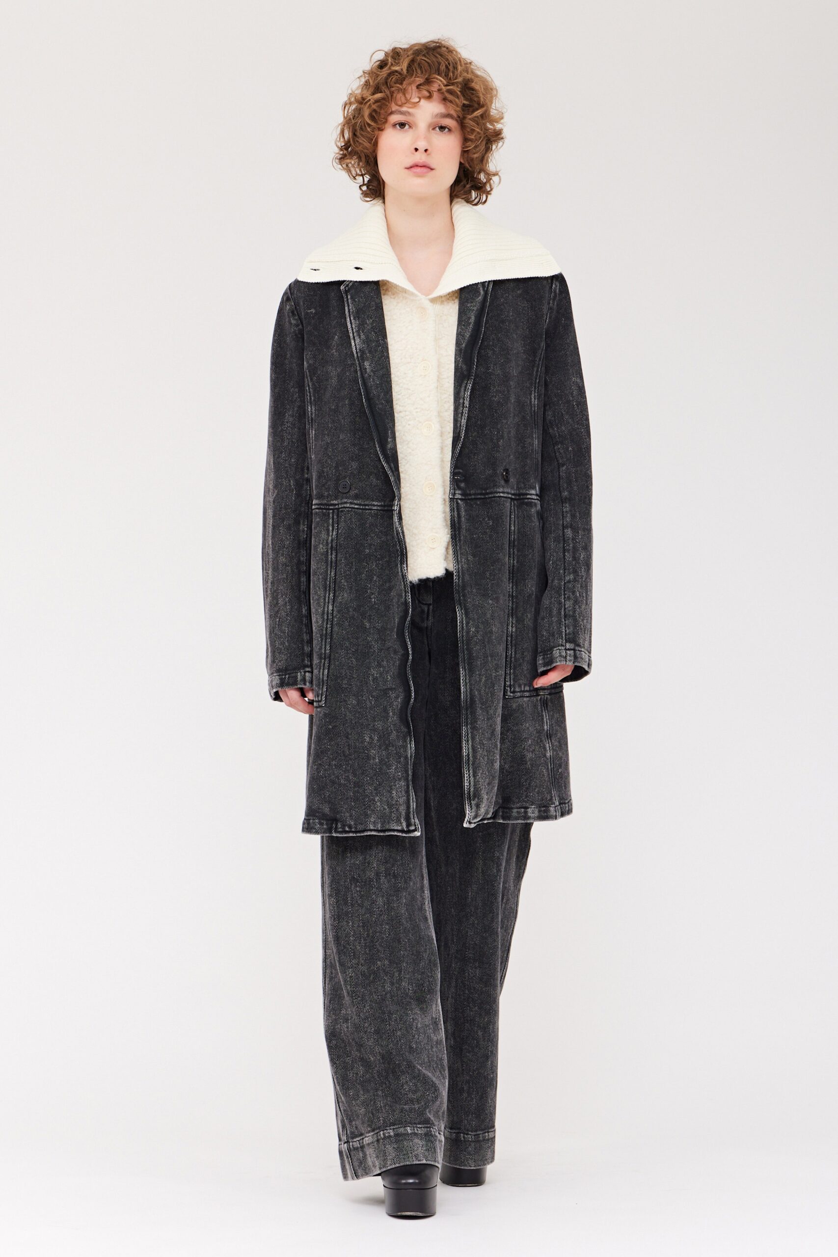 A relaxed black denim coat with a collared neckline paired with matching relaxed pants.