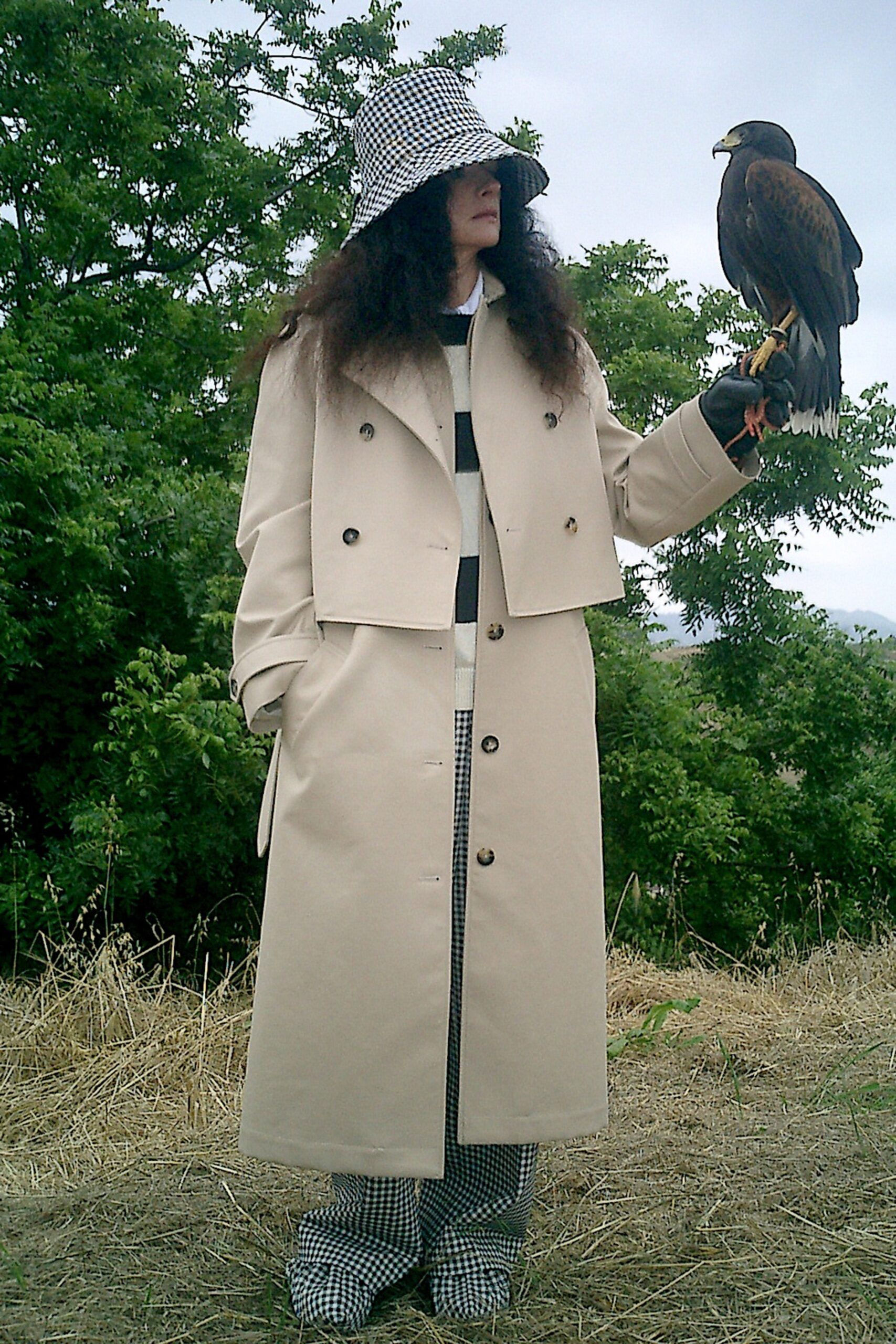 A relaxed beige coat with long sleeves and checked pants, perfect for a stylish outdoor look.