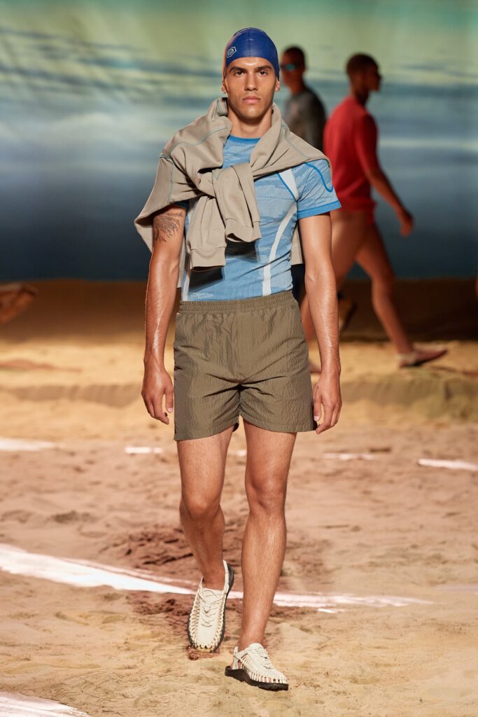 A fitted blue striped t-shirt paired with green shorts, perfect for a casual summer look.