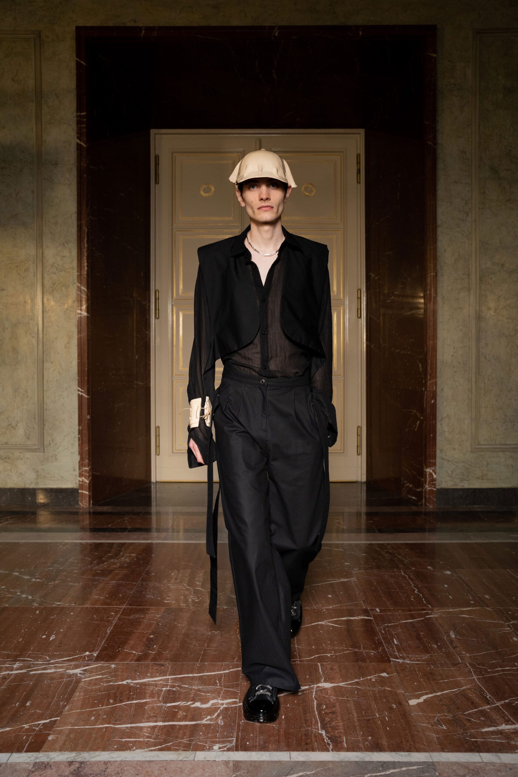 A relaxed black jacket with long sleeves and collared design paired with matching pants.