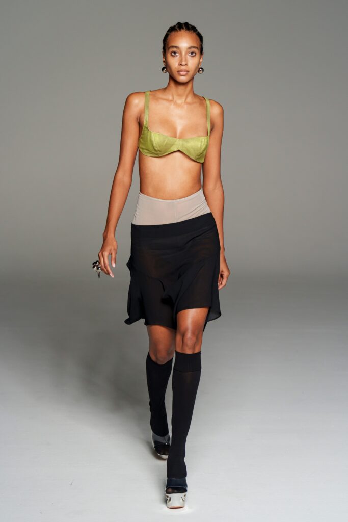 green silk bustier and black skirt