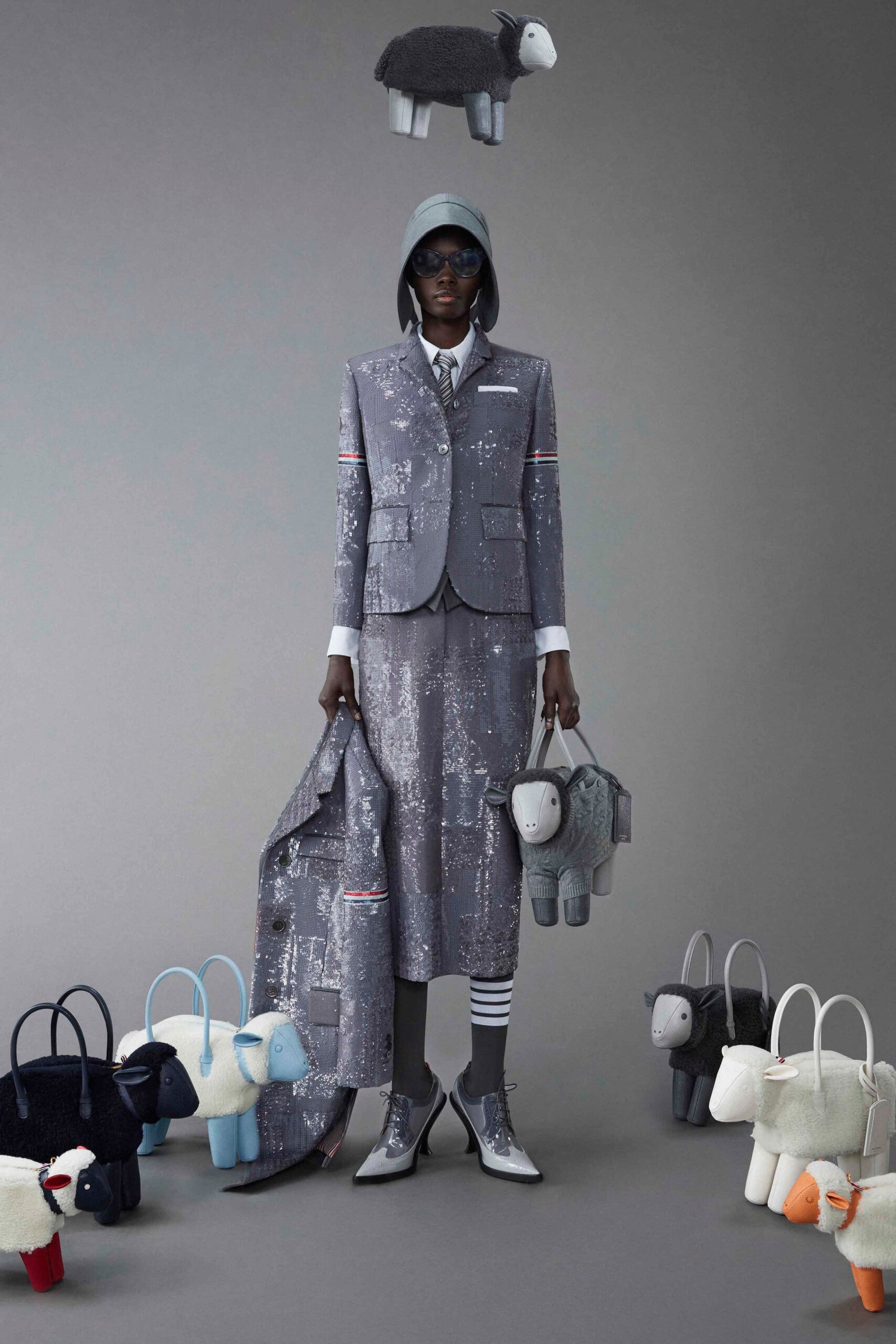 A fitted gray cotton suit with a collared long-sleeve shirt and layered skirt.