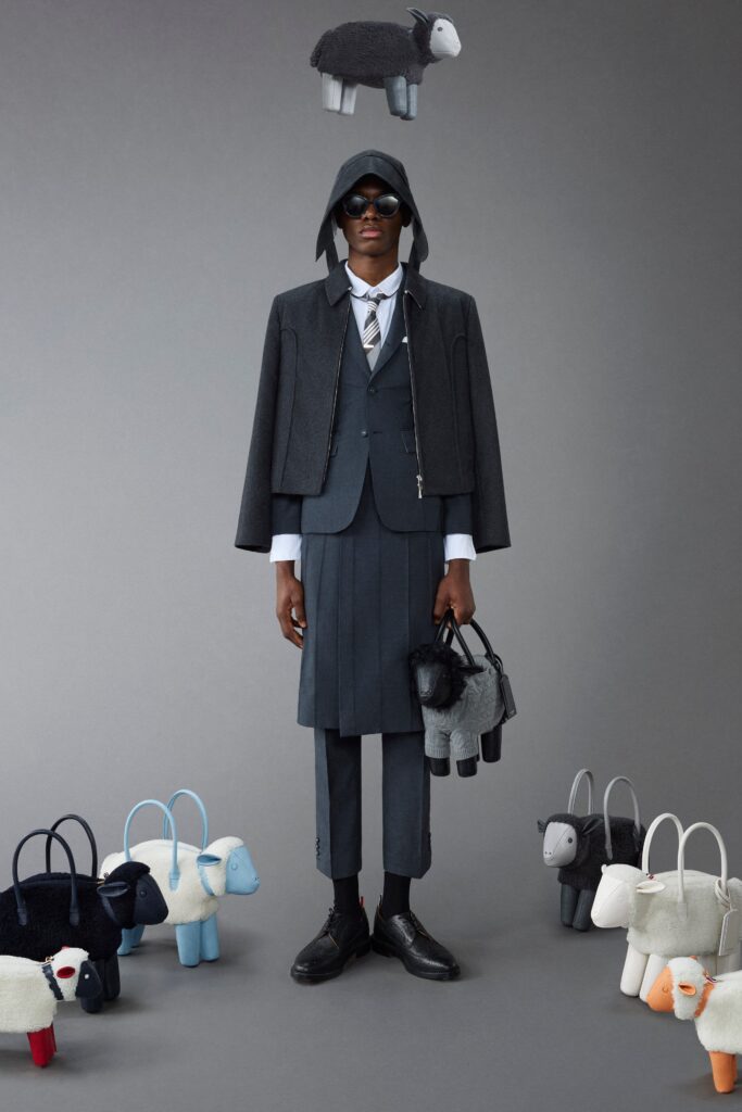 A tailored gray wool suit with an asymmetric jacket and long sleeves.