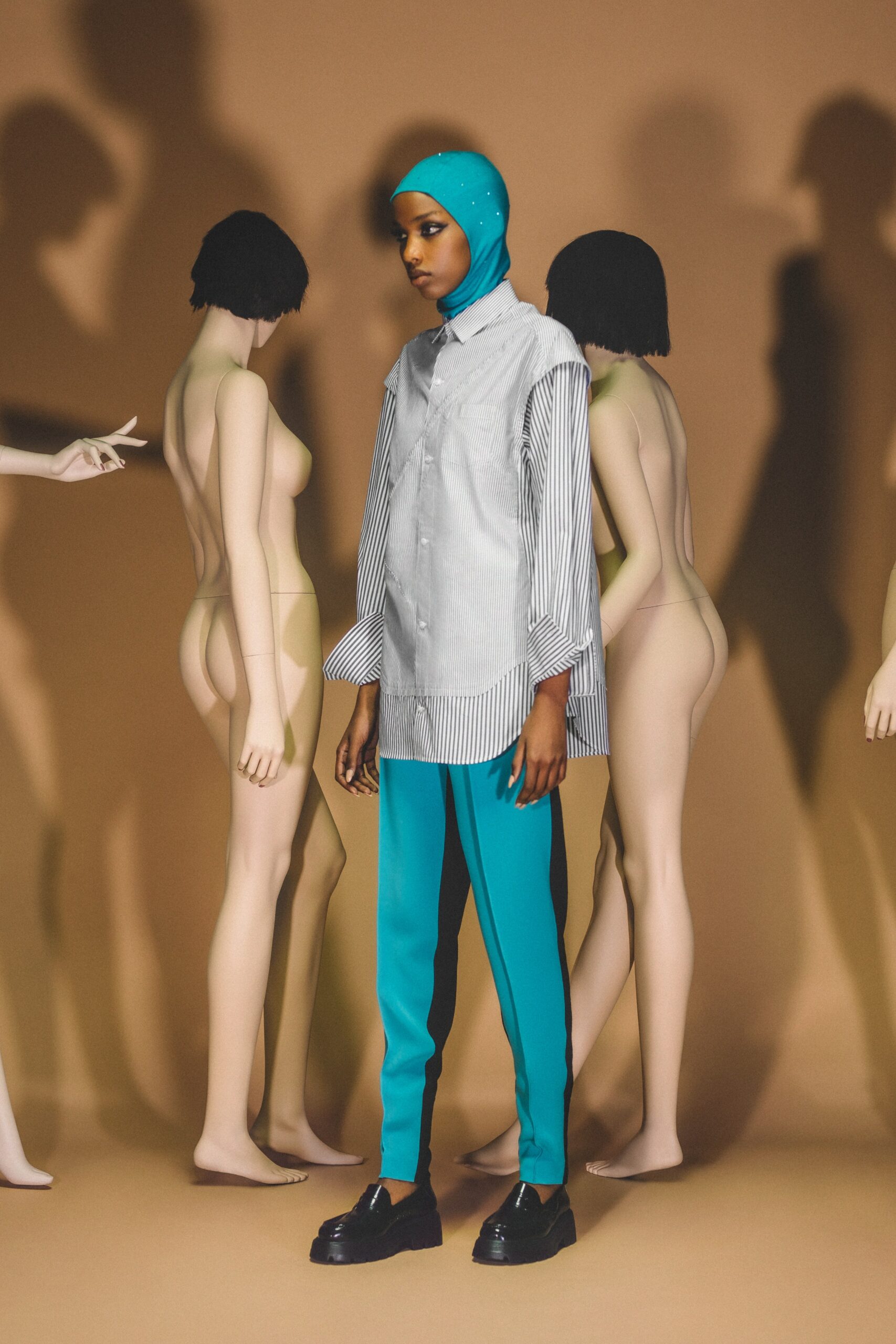 A relaxed gray striped long-sleeve shirt paired with blue straight-leg pants.