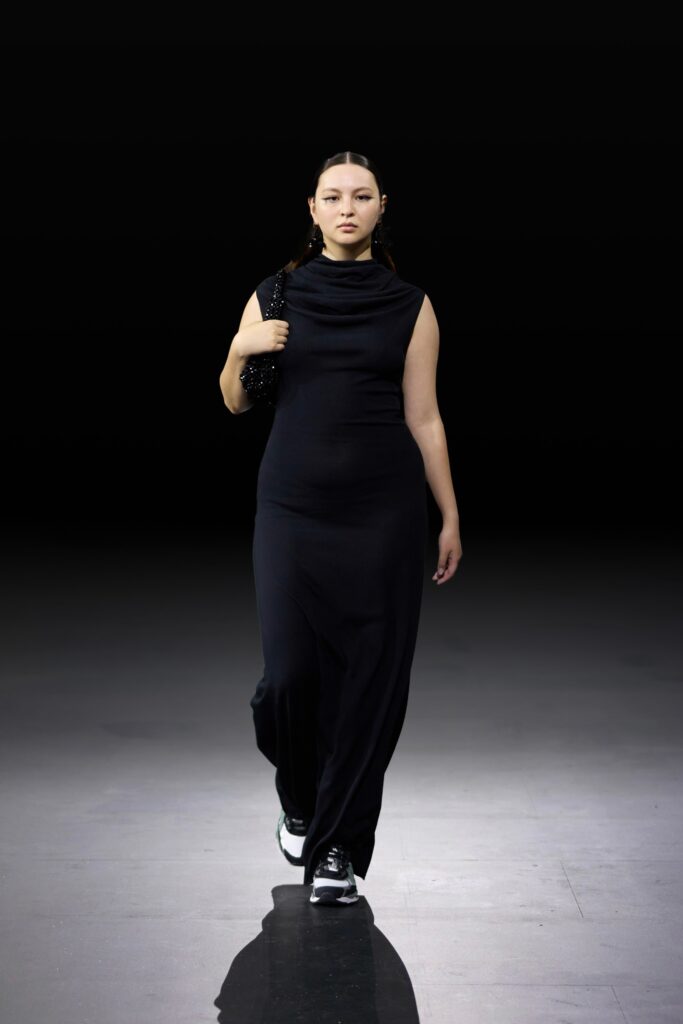 A fitted black sleeveless dress with a sleek silhouette, perfect for a modern look.
