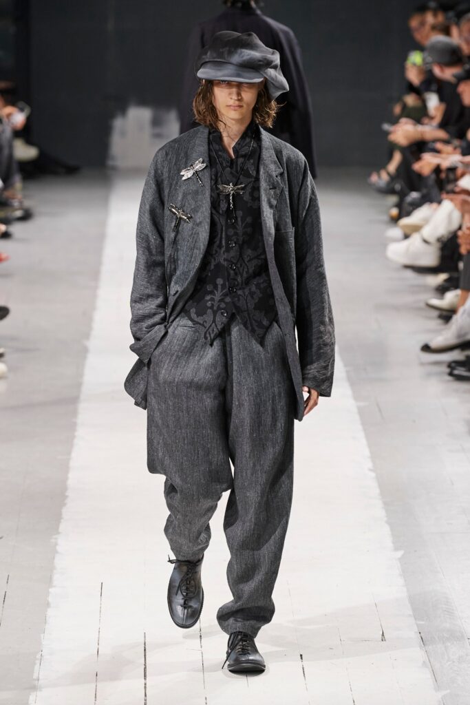 A relaxed gray cotton jacket with long sleeves and collared design, paired with matching pants.