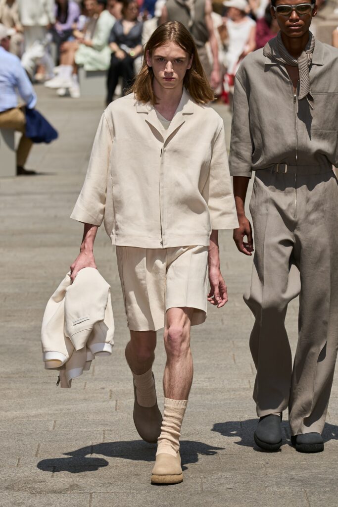 A relaxed beige cotton short-sleeve shirt paired with matching shorts featuring a buttoned design.