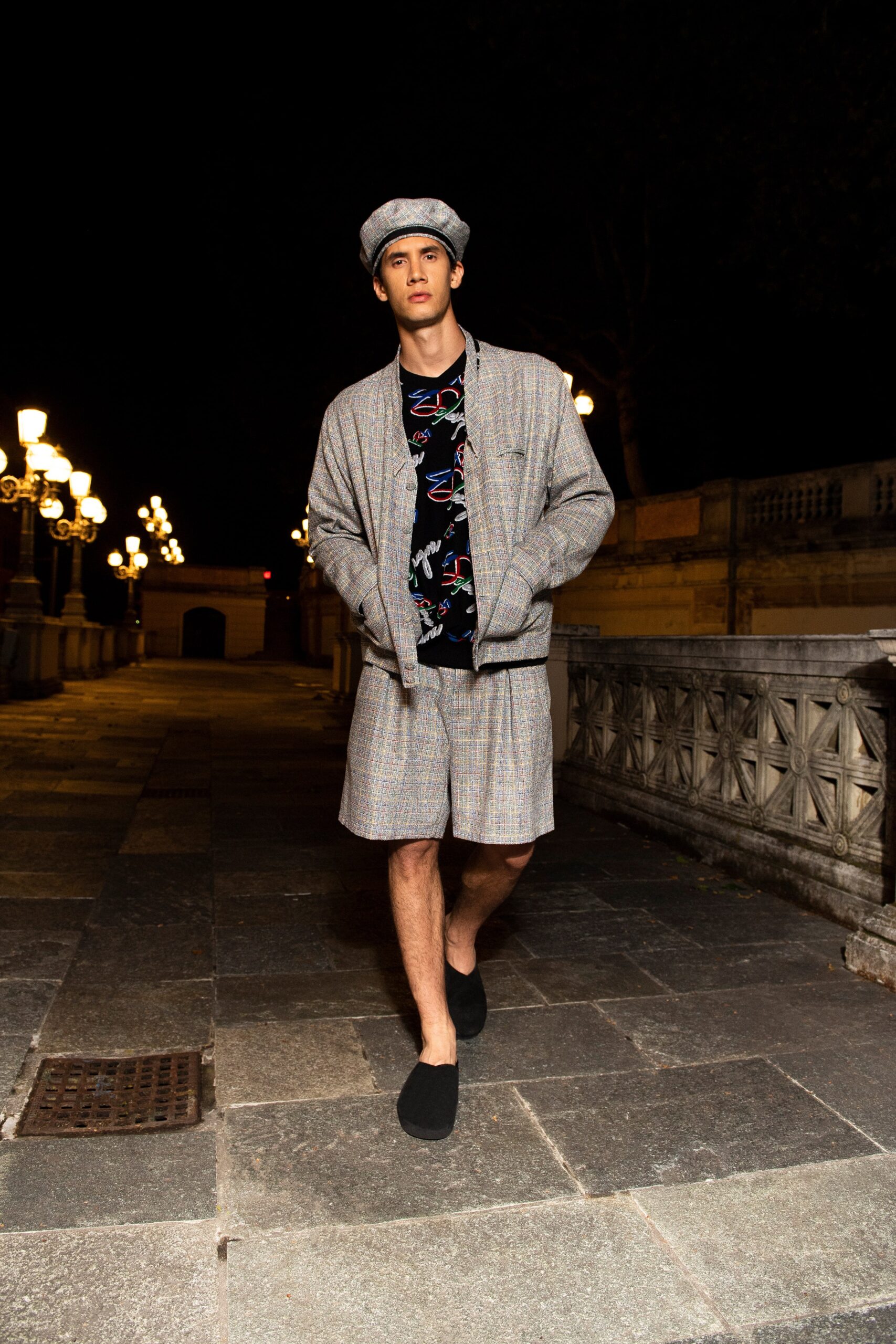 A relaxed gray checked jacket paired with matching shorts for a stylish summer look.