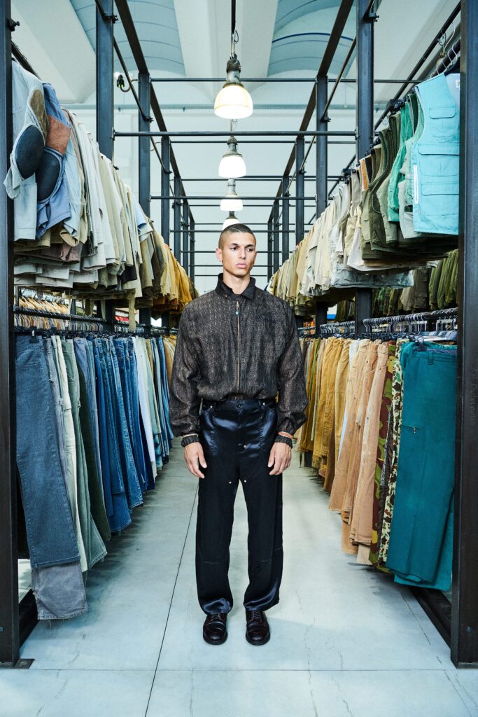 A relaxed black long-sleeve collared shirt paired with brown pants, featuring a buttoned design.