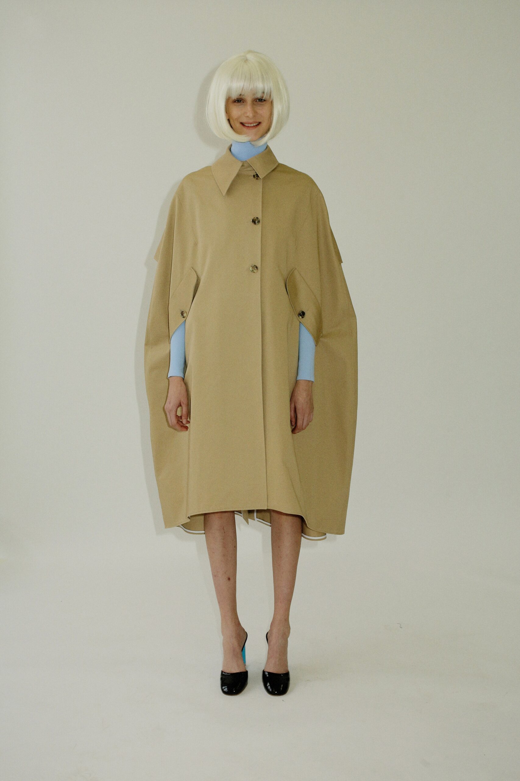 beige cape with blue top