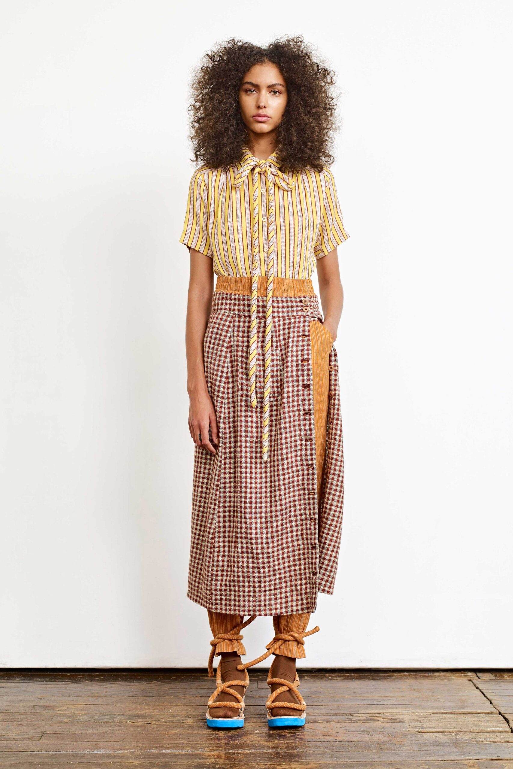 yellow striped shirt and brown checked skirt