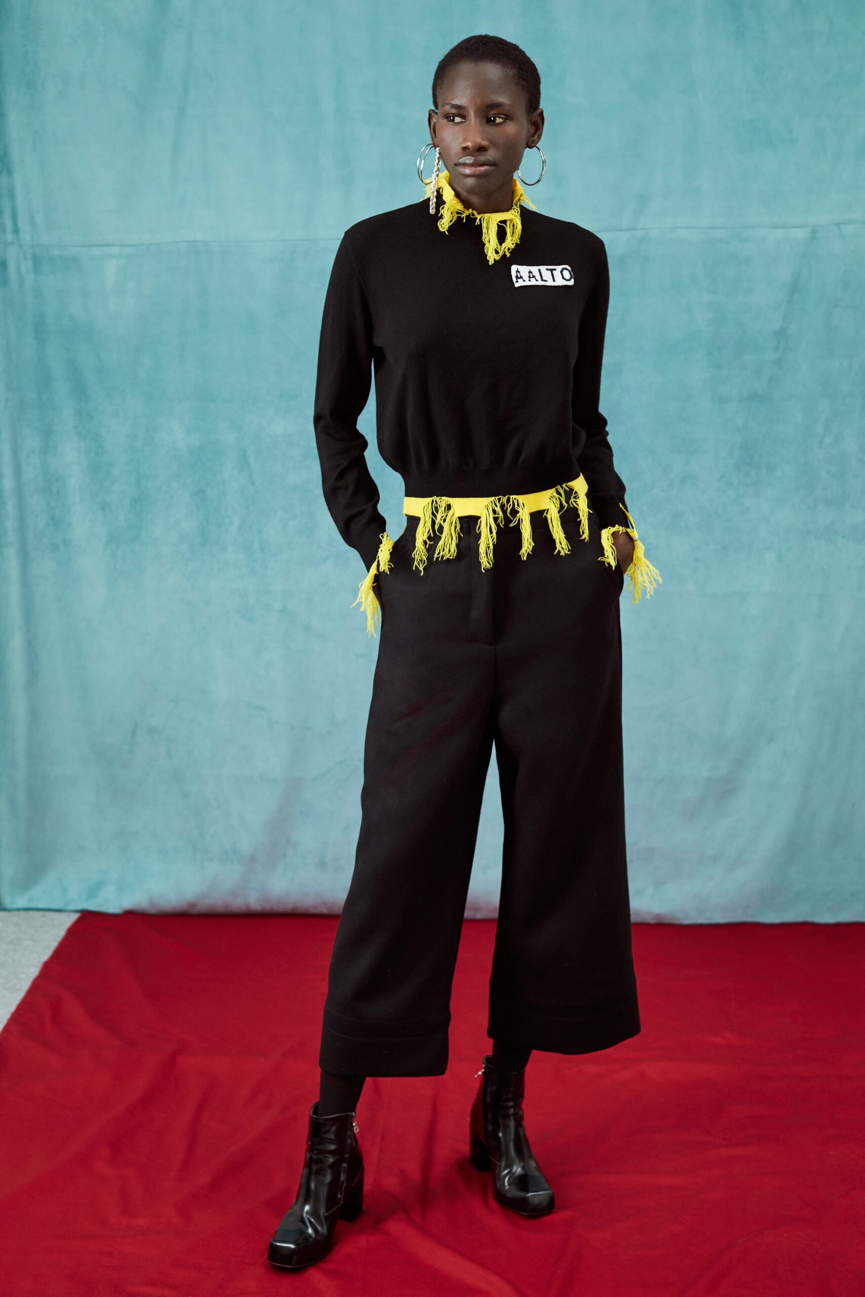 black top with fringes and wide-leg pants