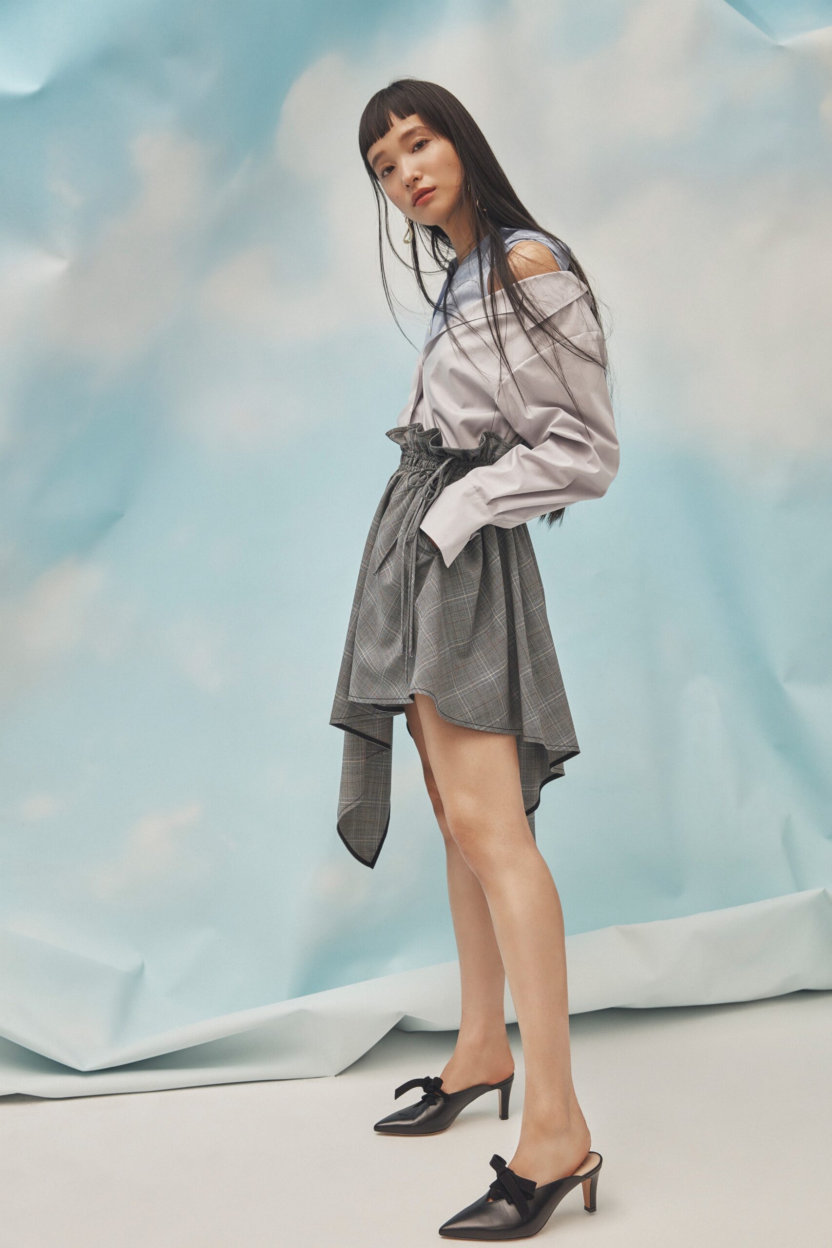 light blue off-shoulder shirt with gray asymmetric skirt