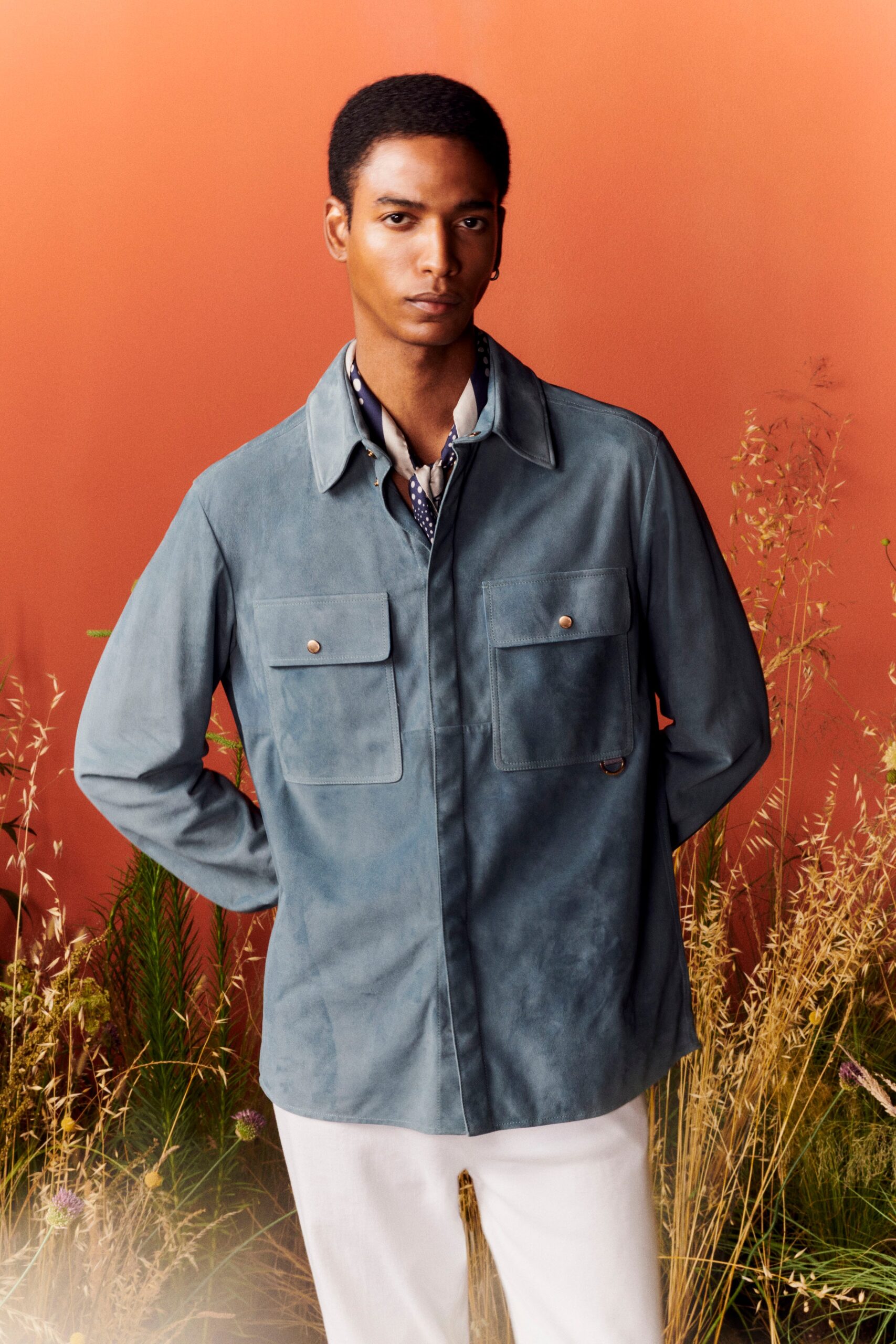 blue suede jacket and white pants