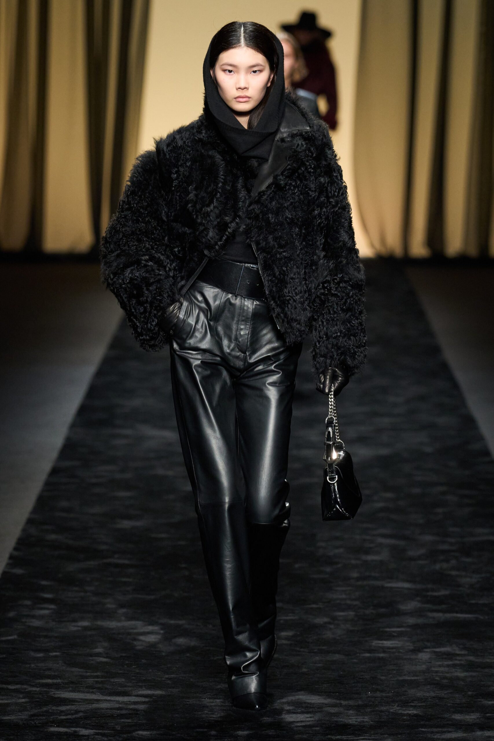 black faux-fur jacket and leather pants