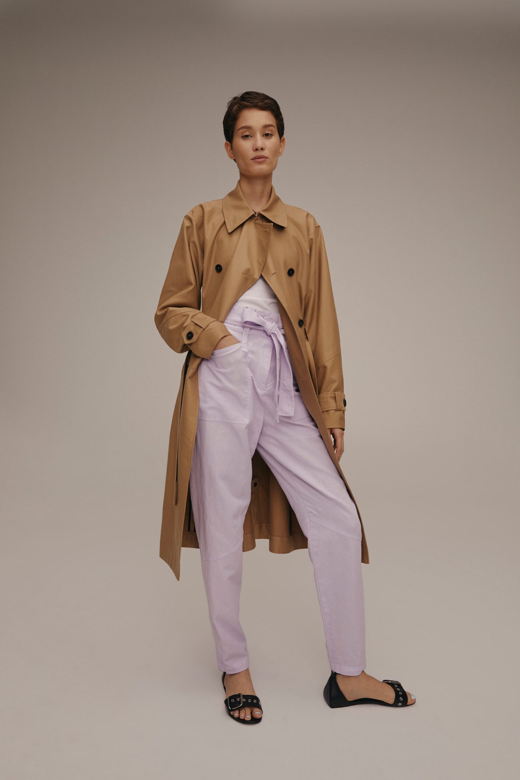 beige trench coat with light purple pants