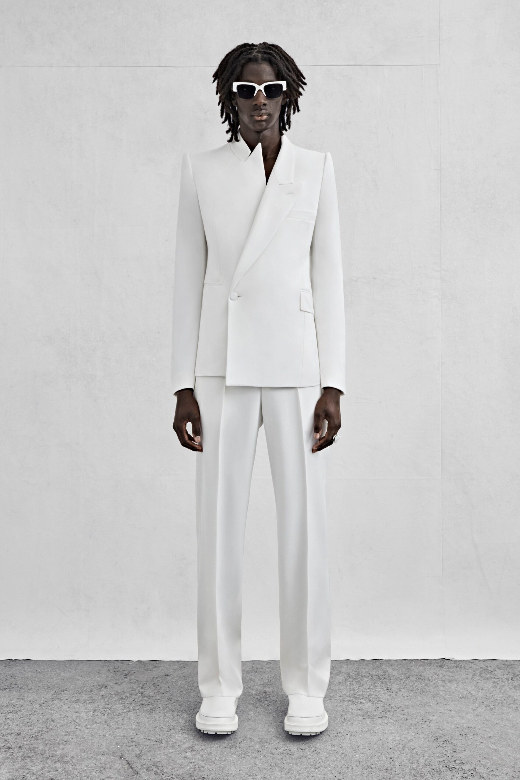 white tailored suit with sunglasses
