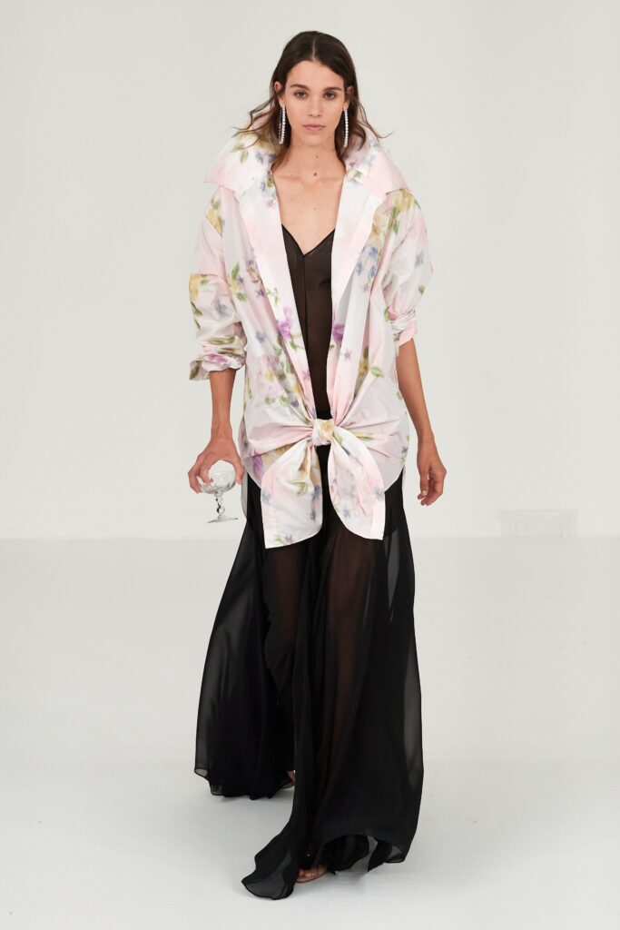 A relaxed black dress layered with a floral collared jacket for a stylish look.