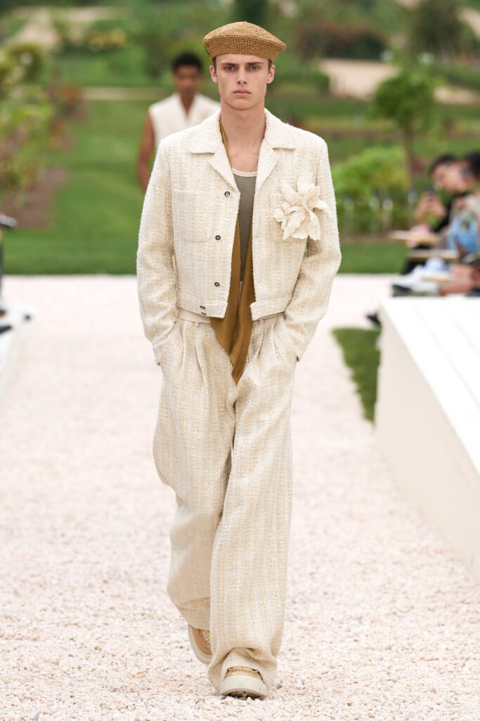 A relaxed beige cotton jacket with long sleeves and collared design paired with matching pants.